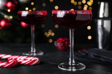 Photo of Delicious Christmas cocktail with liqueur on black table