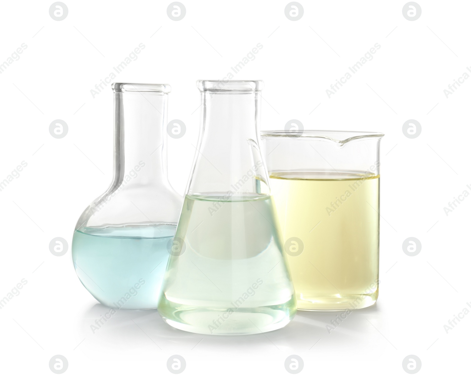 Photo of Laboratory glassware with liquid on white background. Chemical analysis