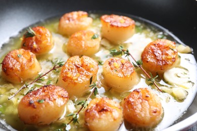 Photo of Delicious scallops with sauce in frying pan, closeup