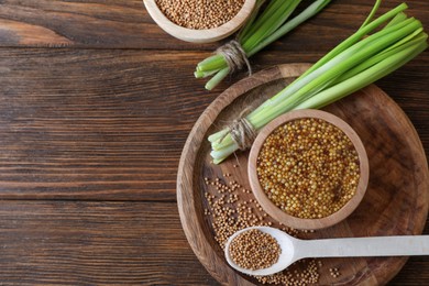 Photo of Tray with delicious whole grain mustard, seeds and fresh green onion on wooden table, flat lay. Space for text