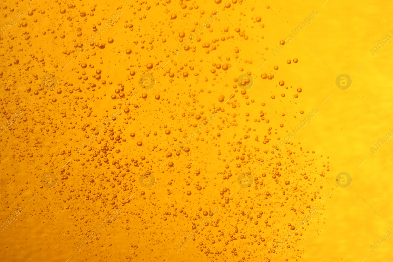 Photo of Tasty beer with bubbles as background, closeup