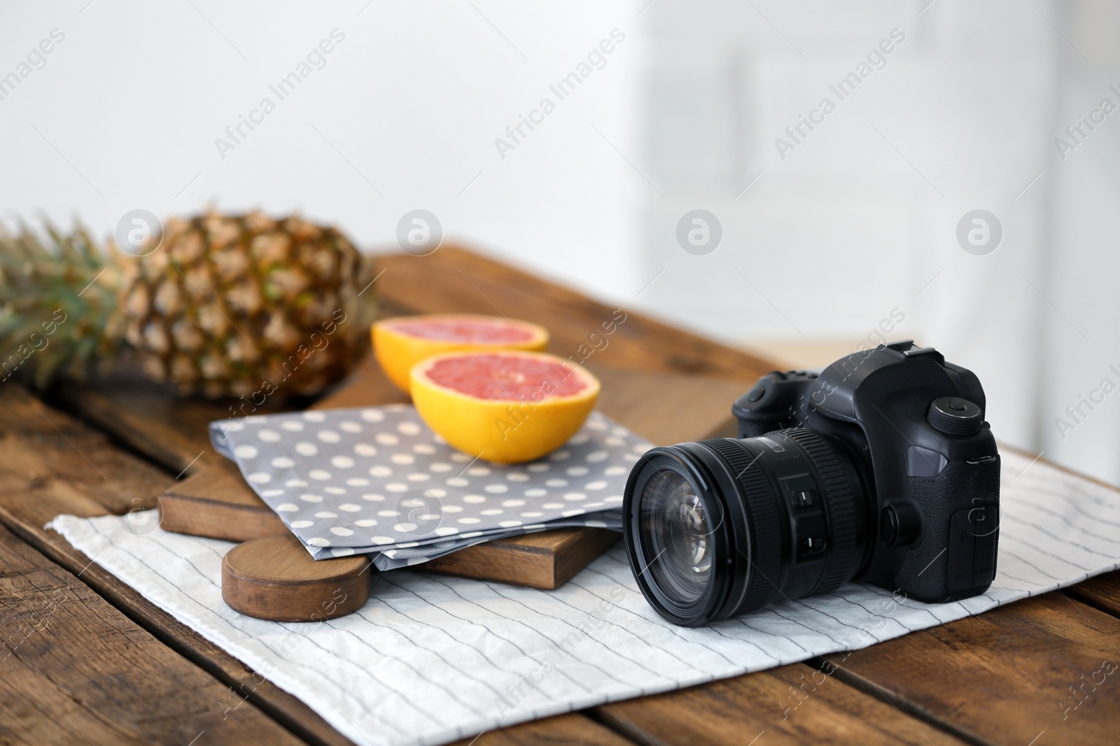 Photo of Professional camera and fruits on table. Food blog