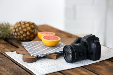 Photo of Professional camera and fruits on table. Food blog