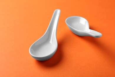 Photo of Clean Miso soup spoons on orange background