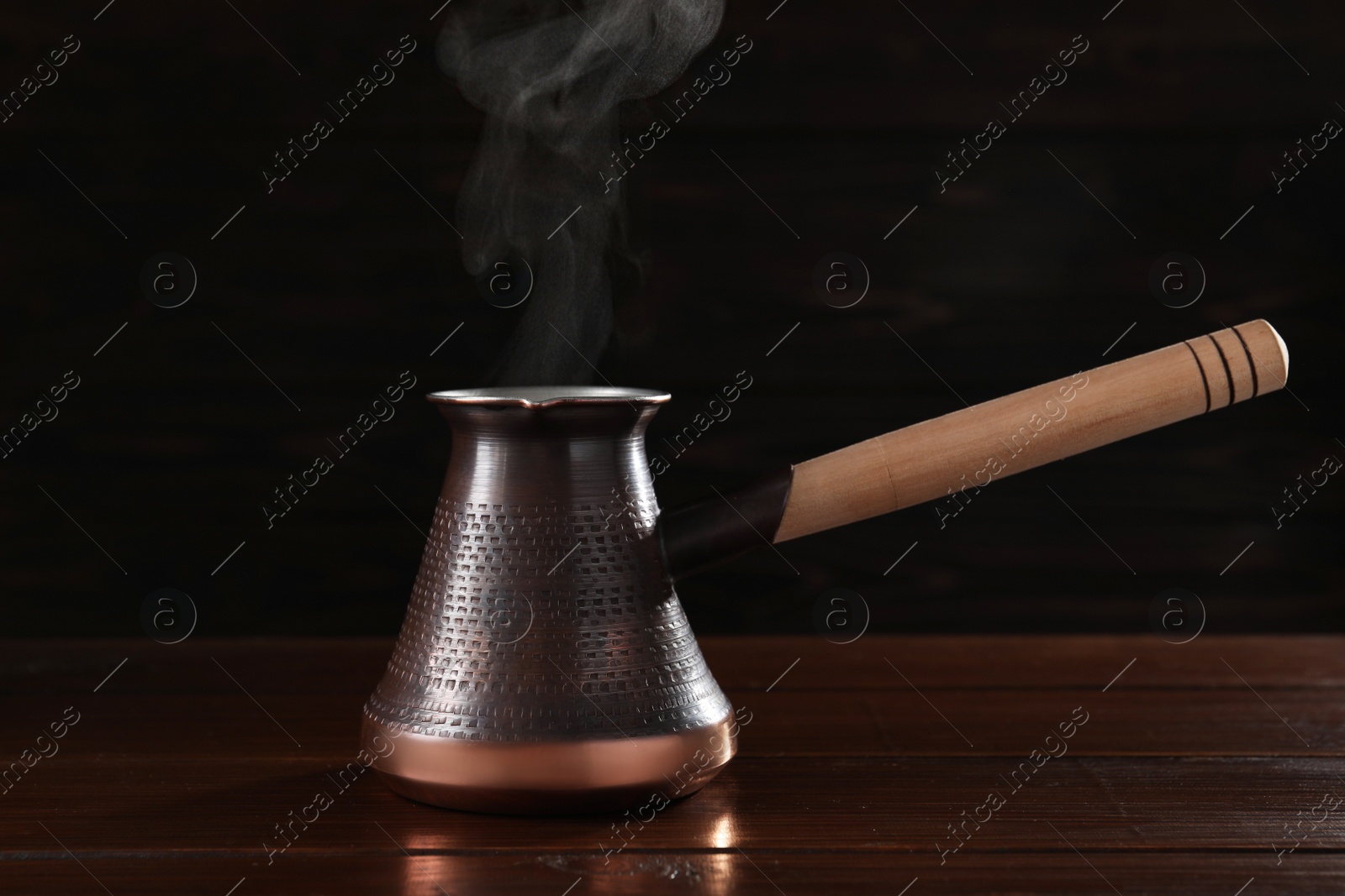 Photo of Turkish coffee in cezve on wooden table