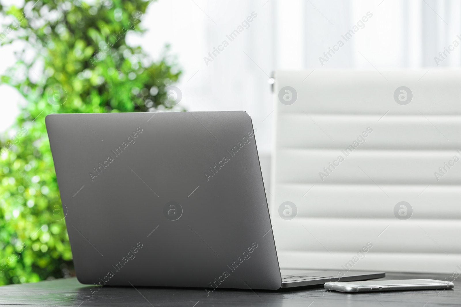 Photo of Laptop on desk in home office. Comfortable workplace