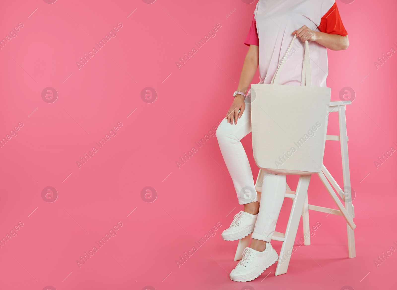 Photo of Woman sitting with eco bag on color background. Mock up for design