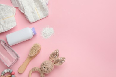 Photo of Flat lay composition with dusting powder and other baby care products on pink background, space for text