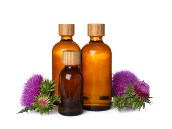 Photo of Bottles of essential oil and flowers on white background