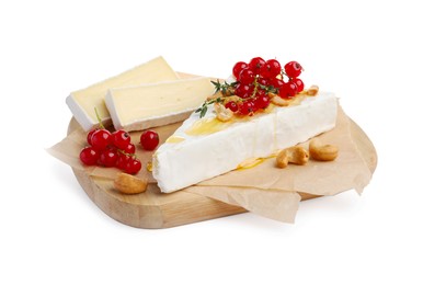 Photo of Brie cheese served with red currants, nuts and honey isolated on white