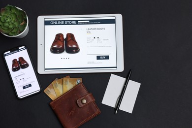 Photo of Online shopping. Flat lay composition with modern tablet and smartphone on black background