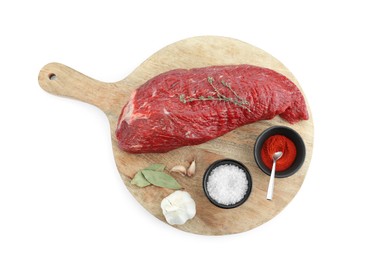 Photo of Piece of raw beef meat and spices isolated on white, top view