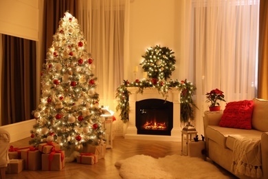 Photo of Festive living room interior with Christmas tree and fireplace