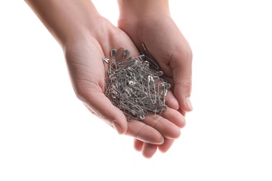Photo of Woman holding pile of safety pins on white background, closeup