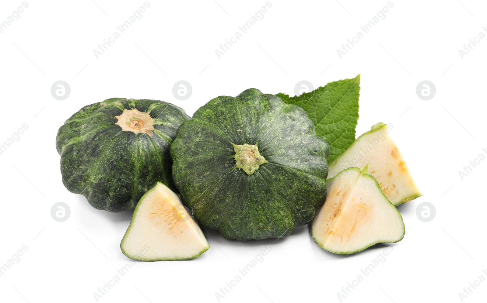 Photo of Whole and cut green pattypan squashes with leaf on white background