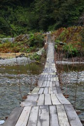 Beautiful view on wooden bridge over river in mountains