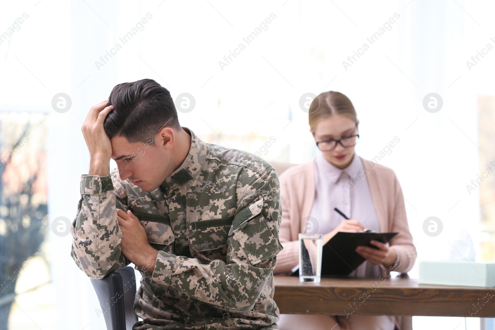 Photo of Psychotherapist working with military officer in office