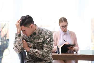 Photo of Psychotherapist working with military officer in office