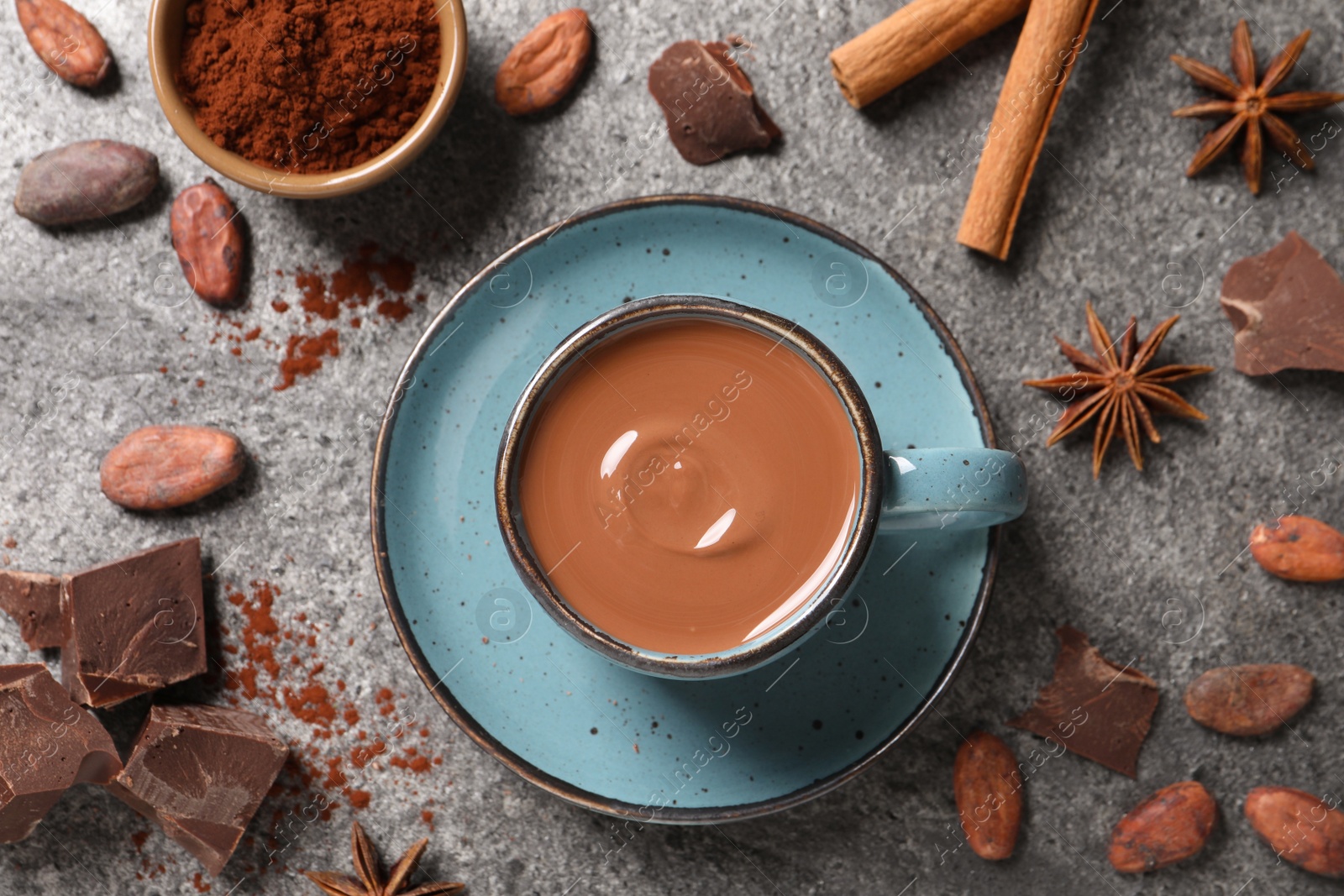 Photo of Flat lay composition with yummy hot chocolate on grey table