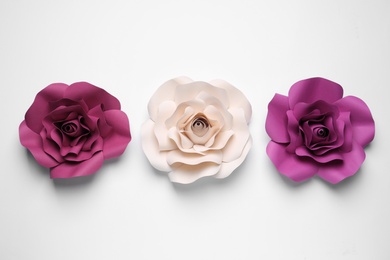 Different beautiful flowers made of paper on white background, top view