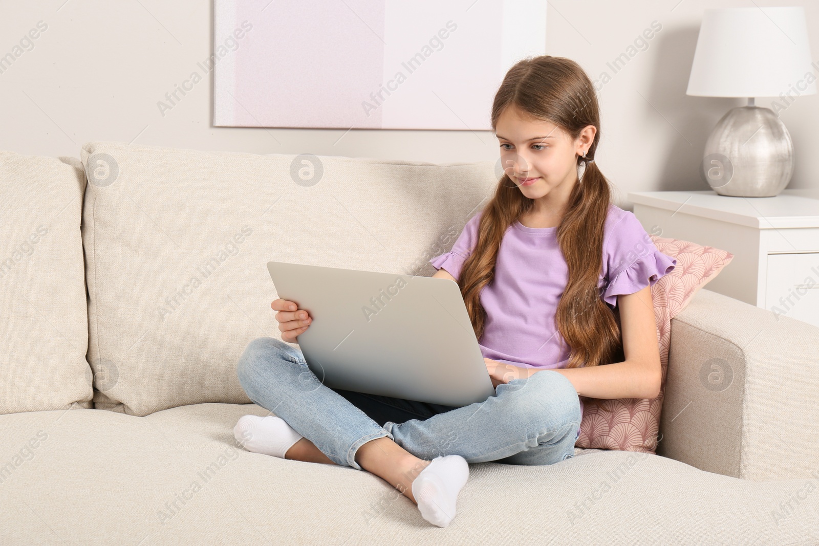 Photo of Girl with laptop on sofa at home