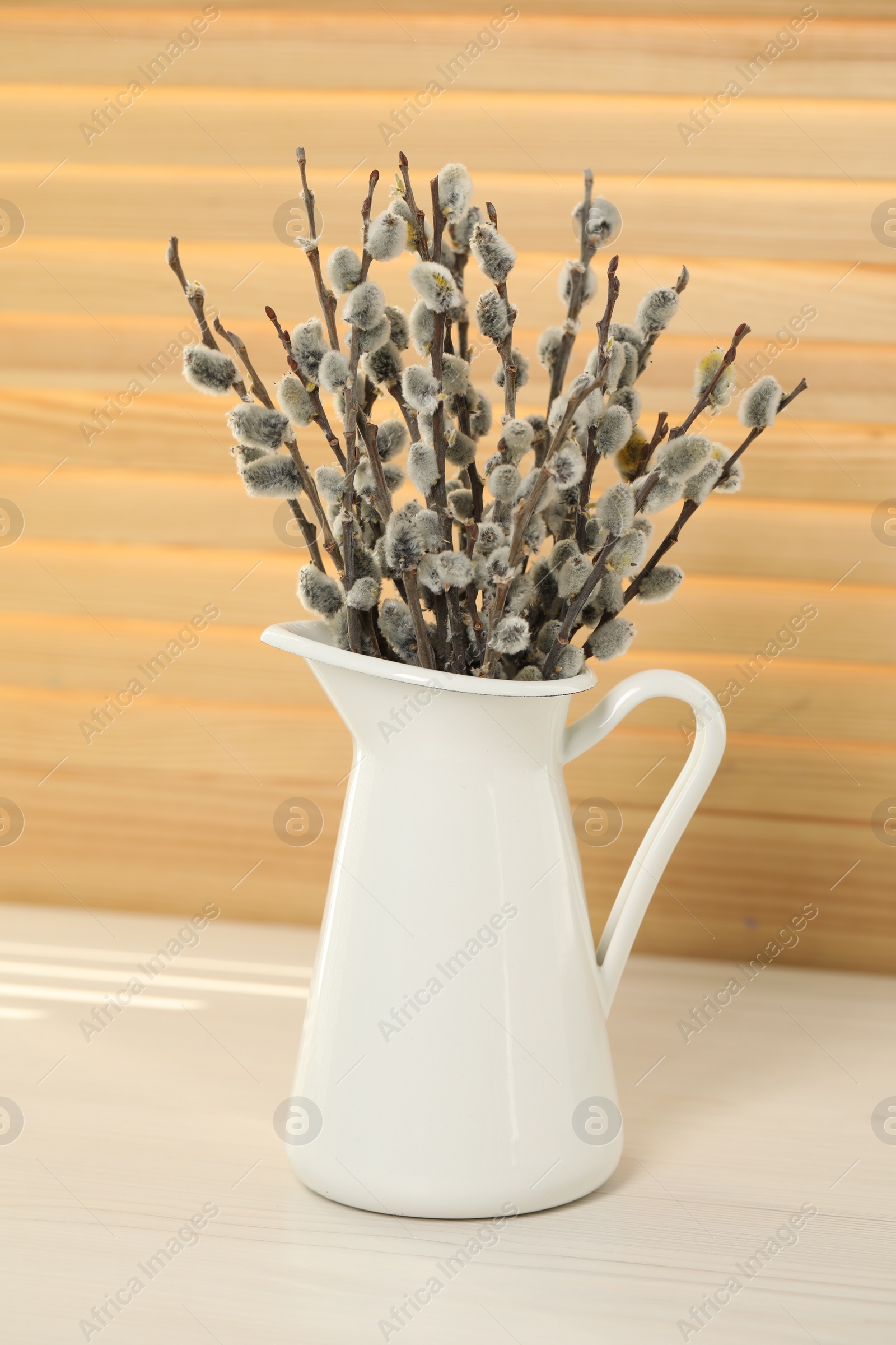 Photo of Beautiful pussy willow branches in vase on white table