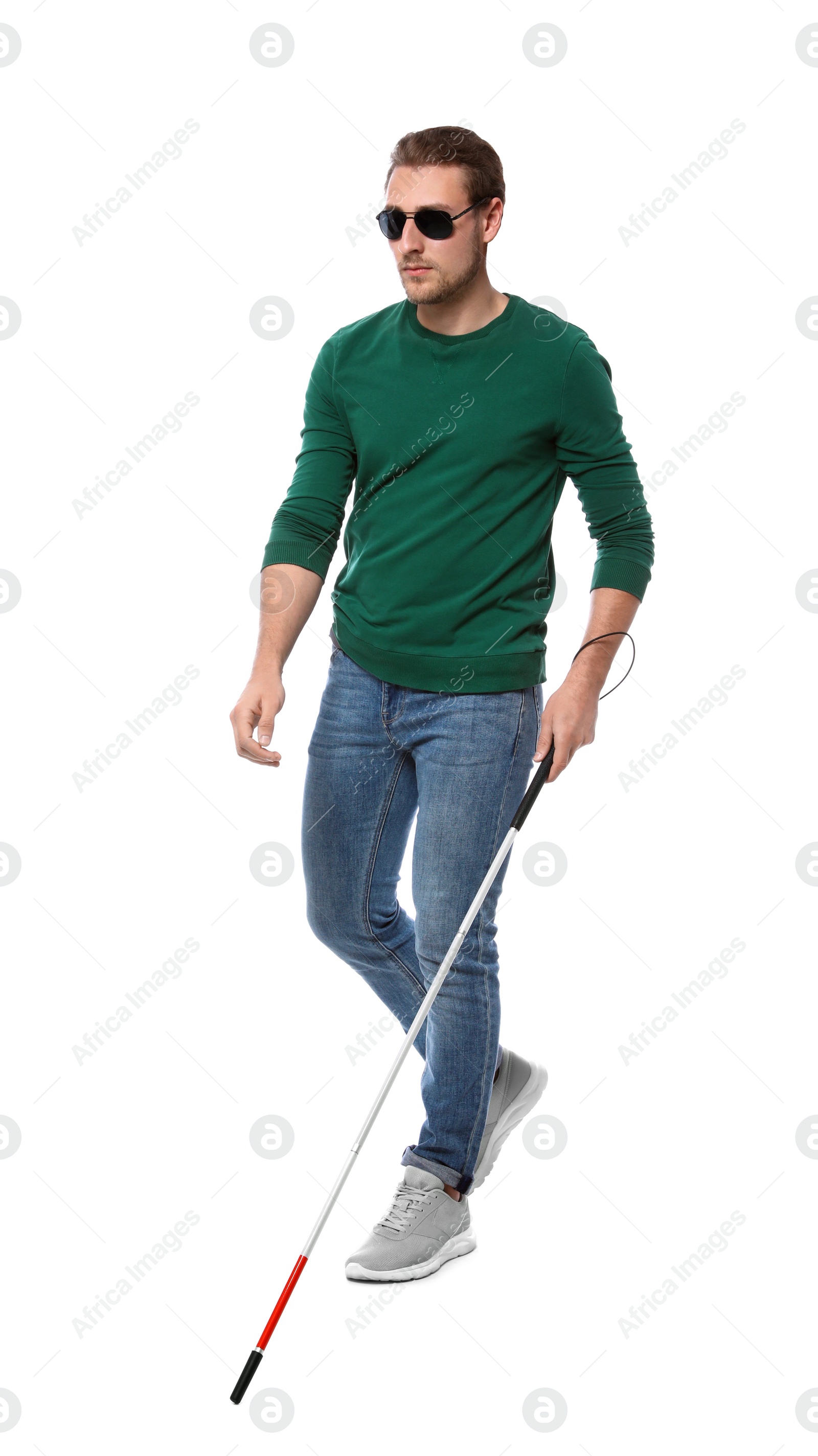 Photo of Blind man in dark glasses with walking cane on white background