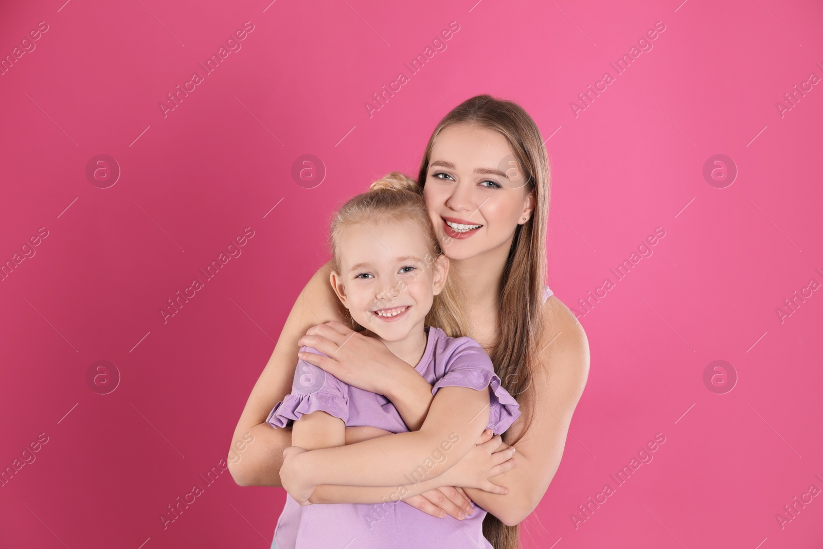 Photo of Happy mother and little daughter on pink background