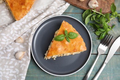 Photo of Delicious meat pie served on blue wooden table, flat lay