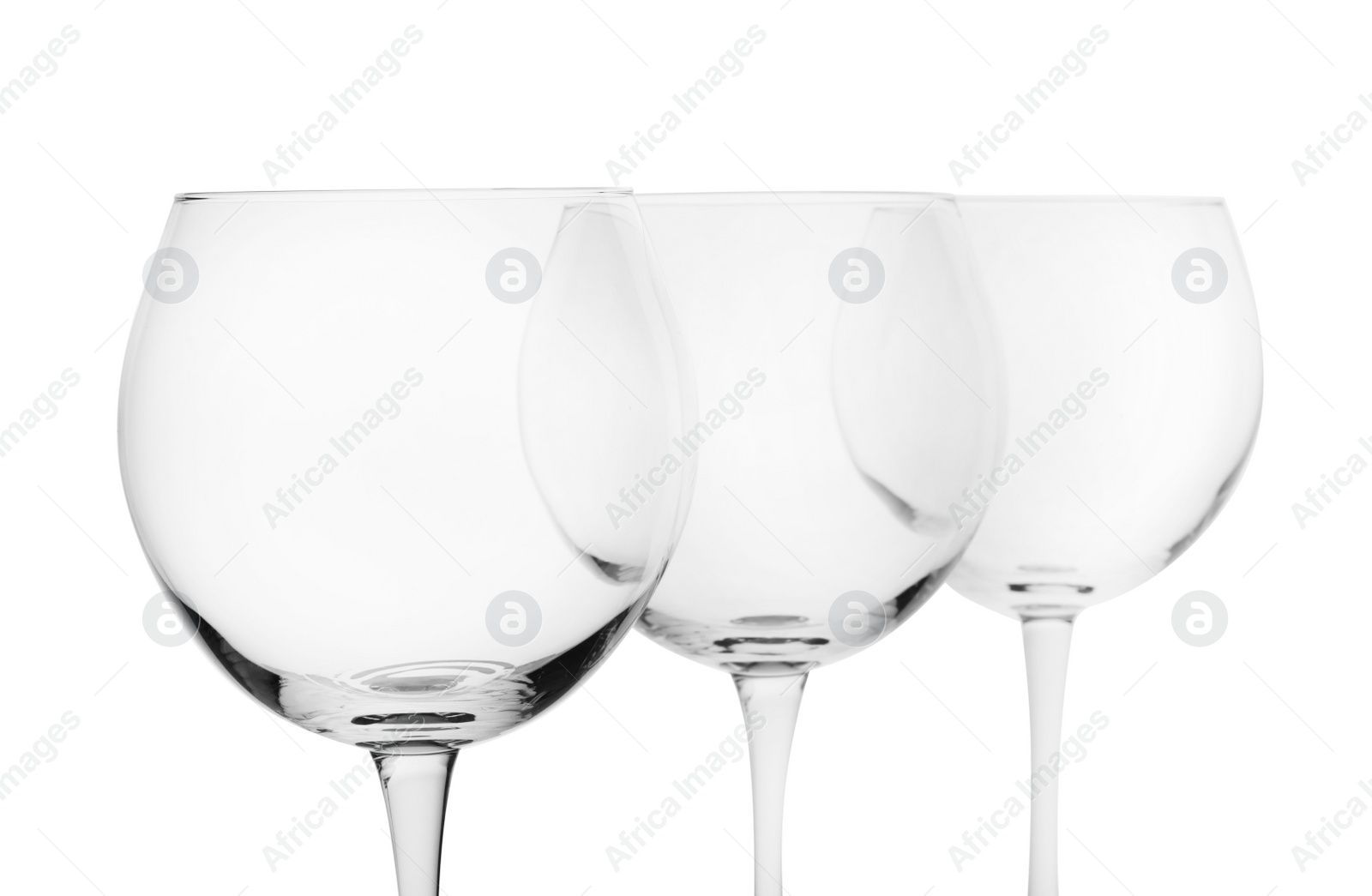 Photo of Empty clear wine glasses on white background