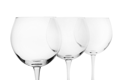 Empty clear wine glasses on white background