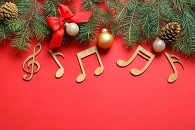 Flat lay composition with decorations and  notes on color background. Christmas music concept