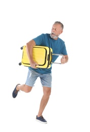 Senior man with suitcase running on white background. Vacation travel