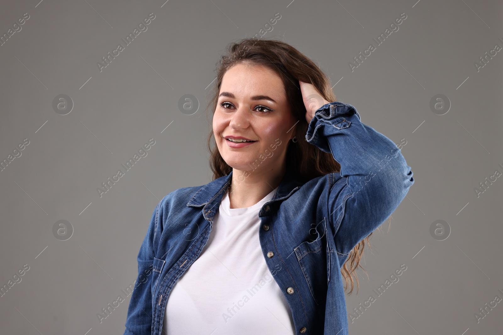 Photo of Portrait of beautiful young woman on grey background