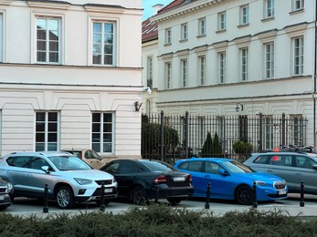 Photo of City street with parked cars and buildings