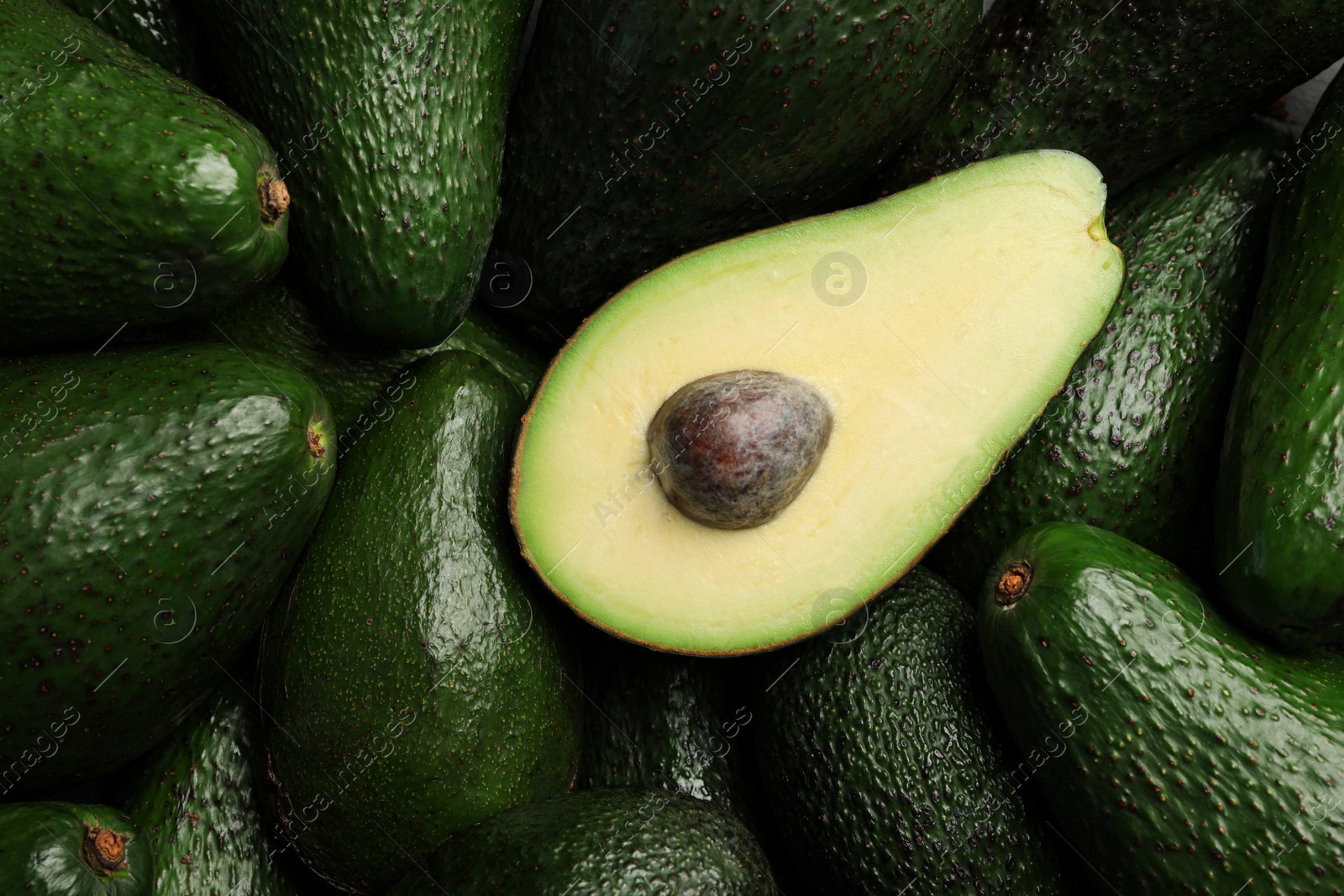 Photo of Delicious ripe avocados as background, closeup view