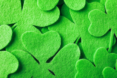 Green clover leaves as background, top view. St. Patrick's Day celebration