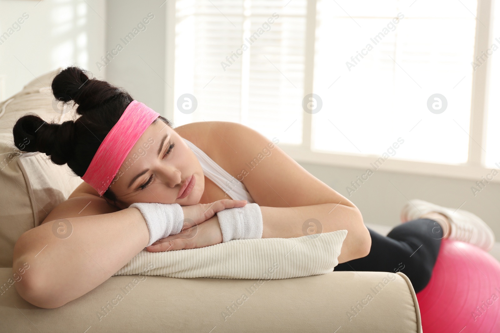 Photo of Lazy overweight woman sleeping instead of morning training
