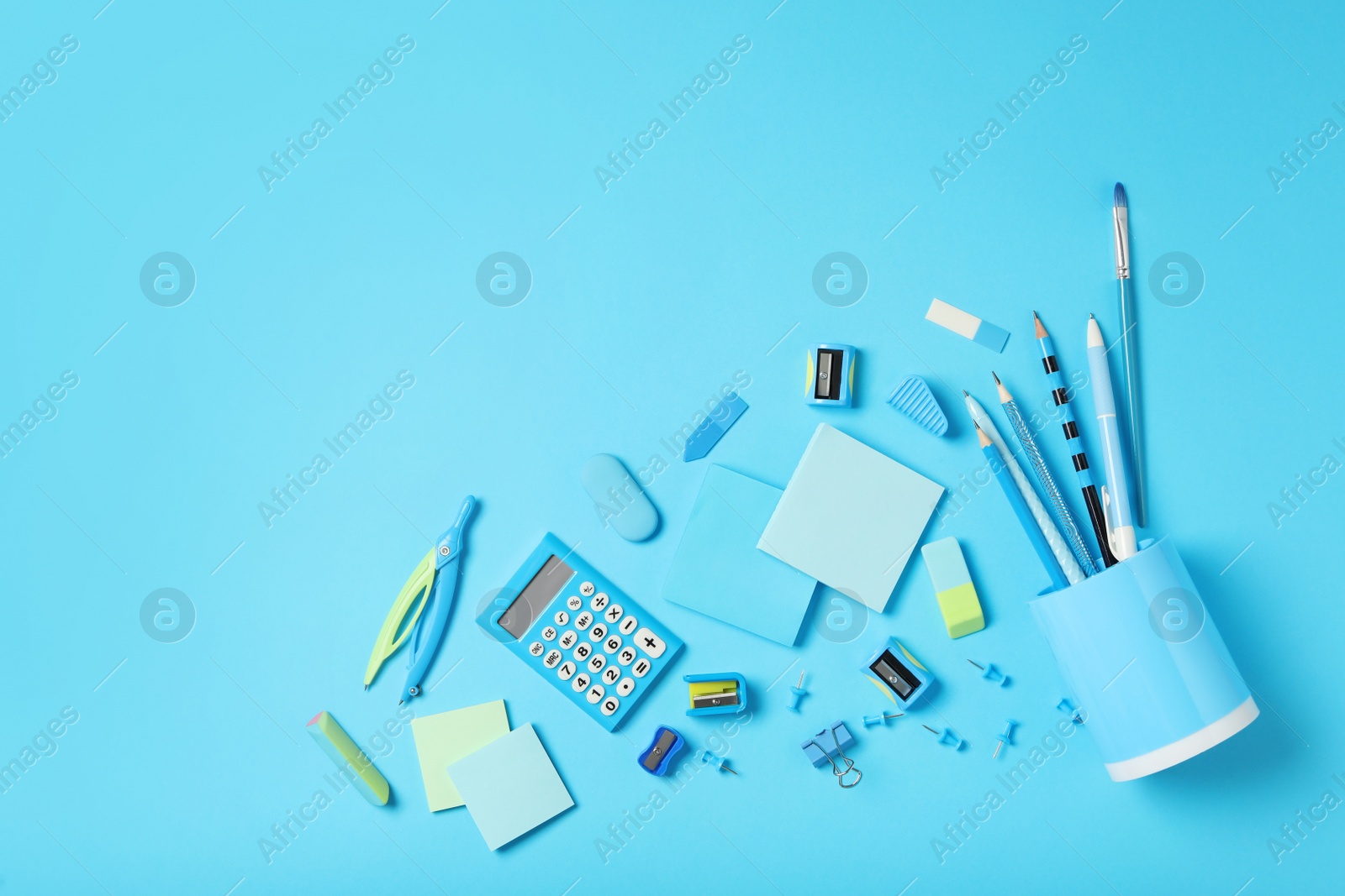 Photo of Different stationery on light blue background, flat lay with space for text. Back to school