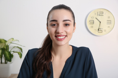 Photo of Young woman using video chat indoors, view from web camera