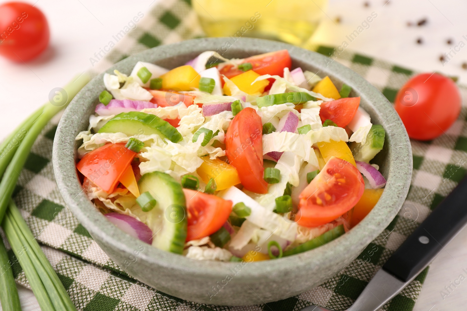 Photo of Tasty salad with Chinese cabbage in bowl on table, closeup