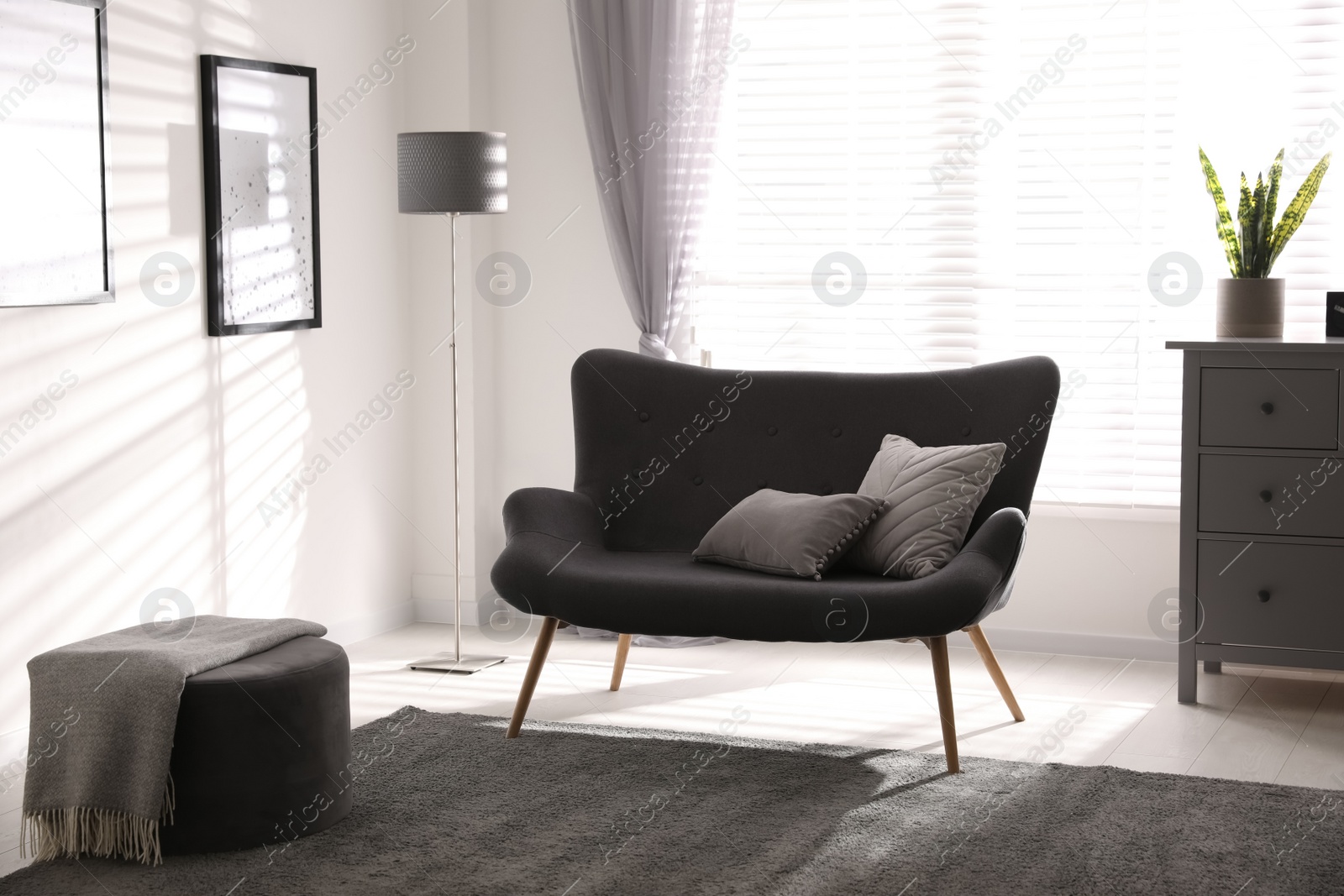 Photo of Stylish living room interior with comfortable sofa near window