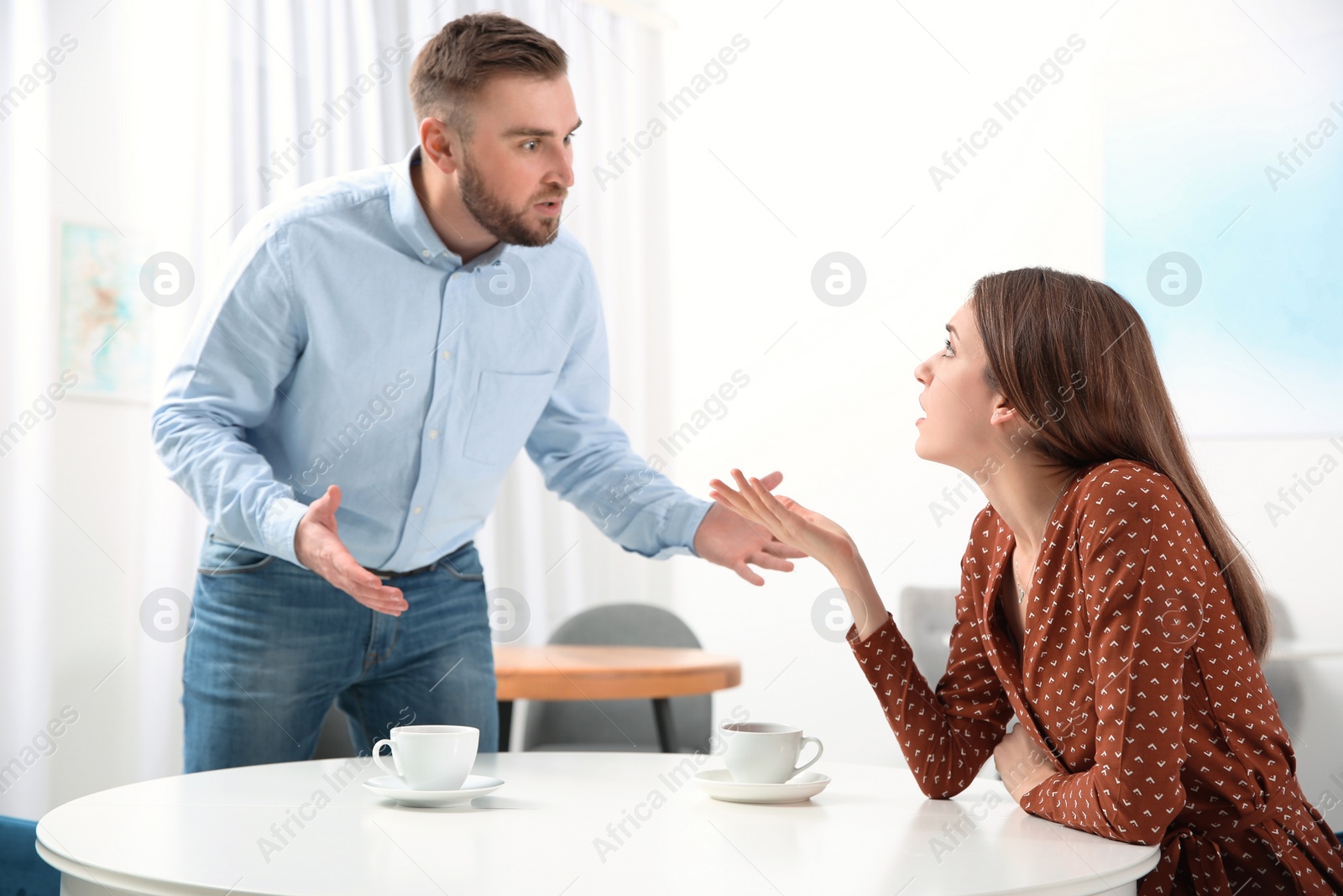 Photo of Couple having quarrel in cafe. Relationship problems