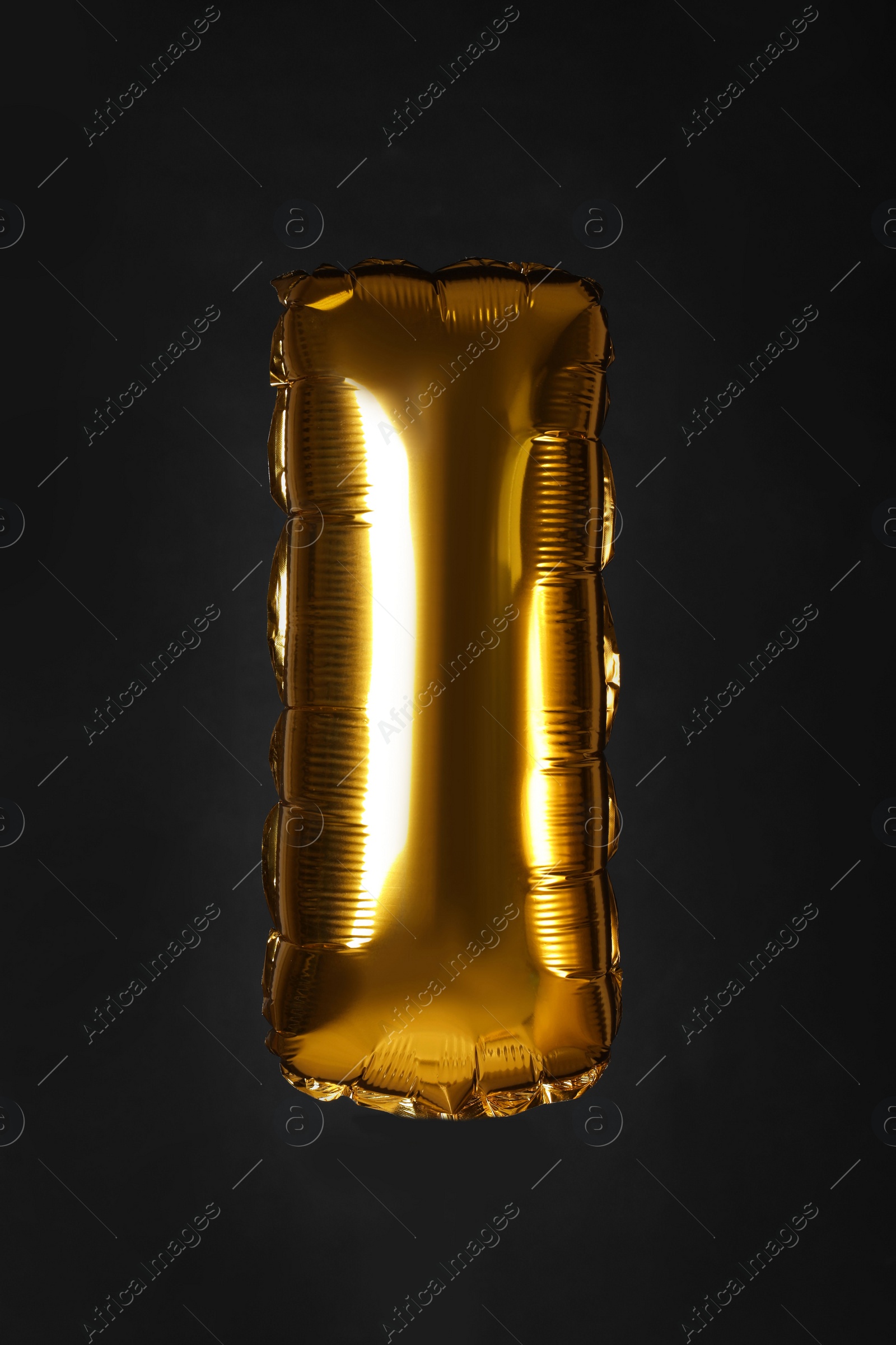 Photo of Golden letter I balloon on black background