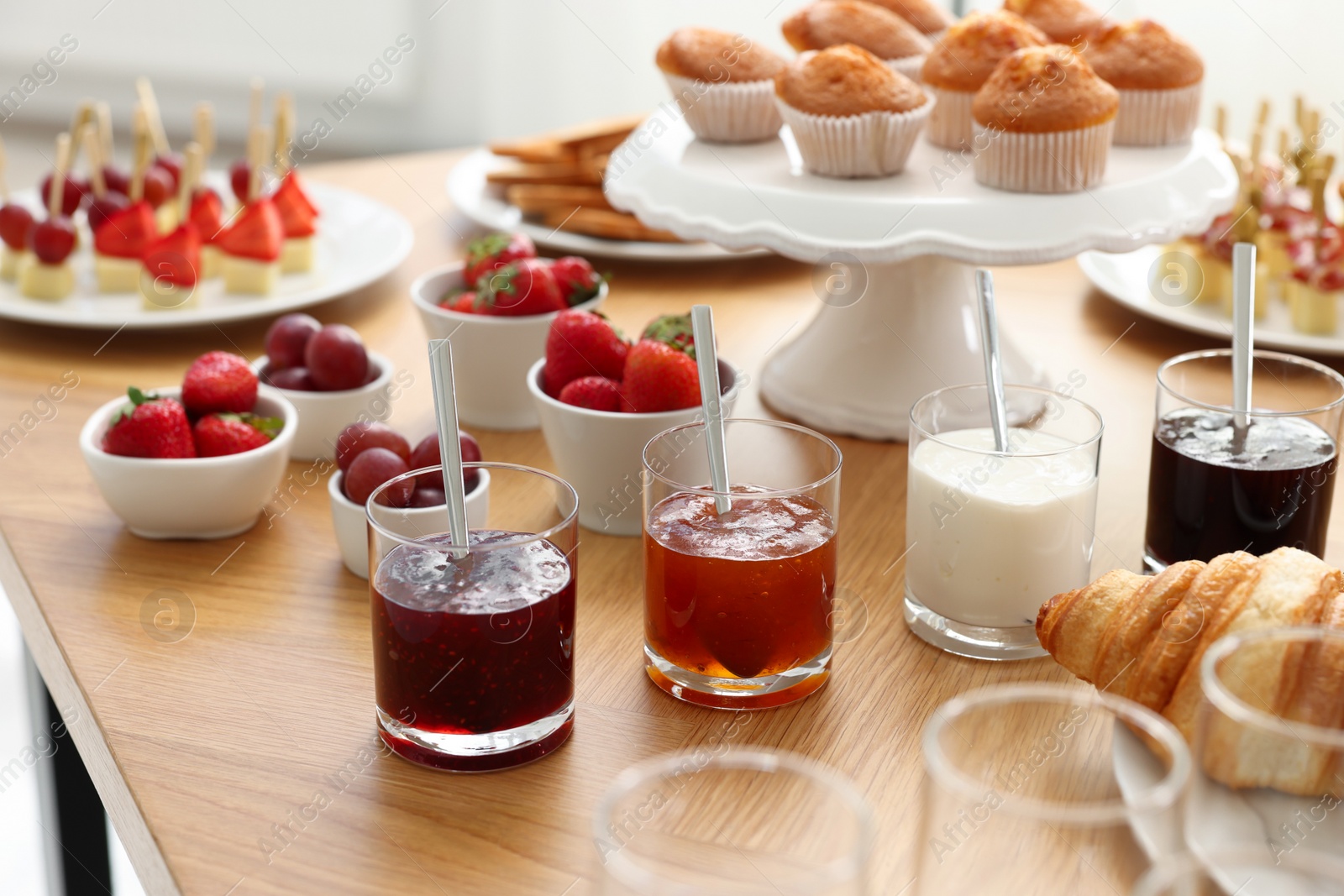 Photo of Different meals served on wooden table indoors. Buffet menu