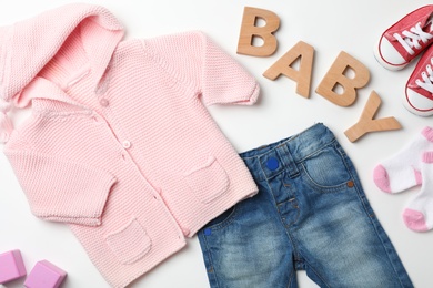 Flat lay composition with baby clothes and accessories on white background