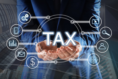 Image of Tax concept. Man demonstrating scheme with icons