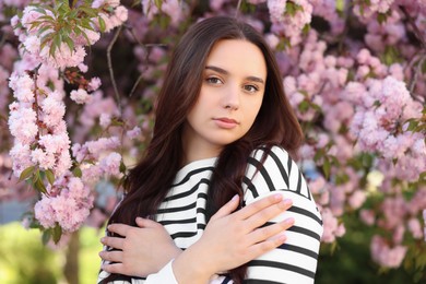 Photo of Beautiful woman near blossoming tree on spring day