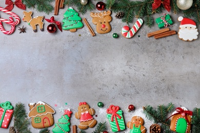 Photo of Decorated Christmas cookies on grey table, flat lay. Space for text