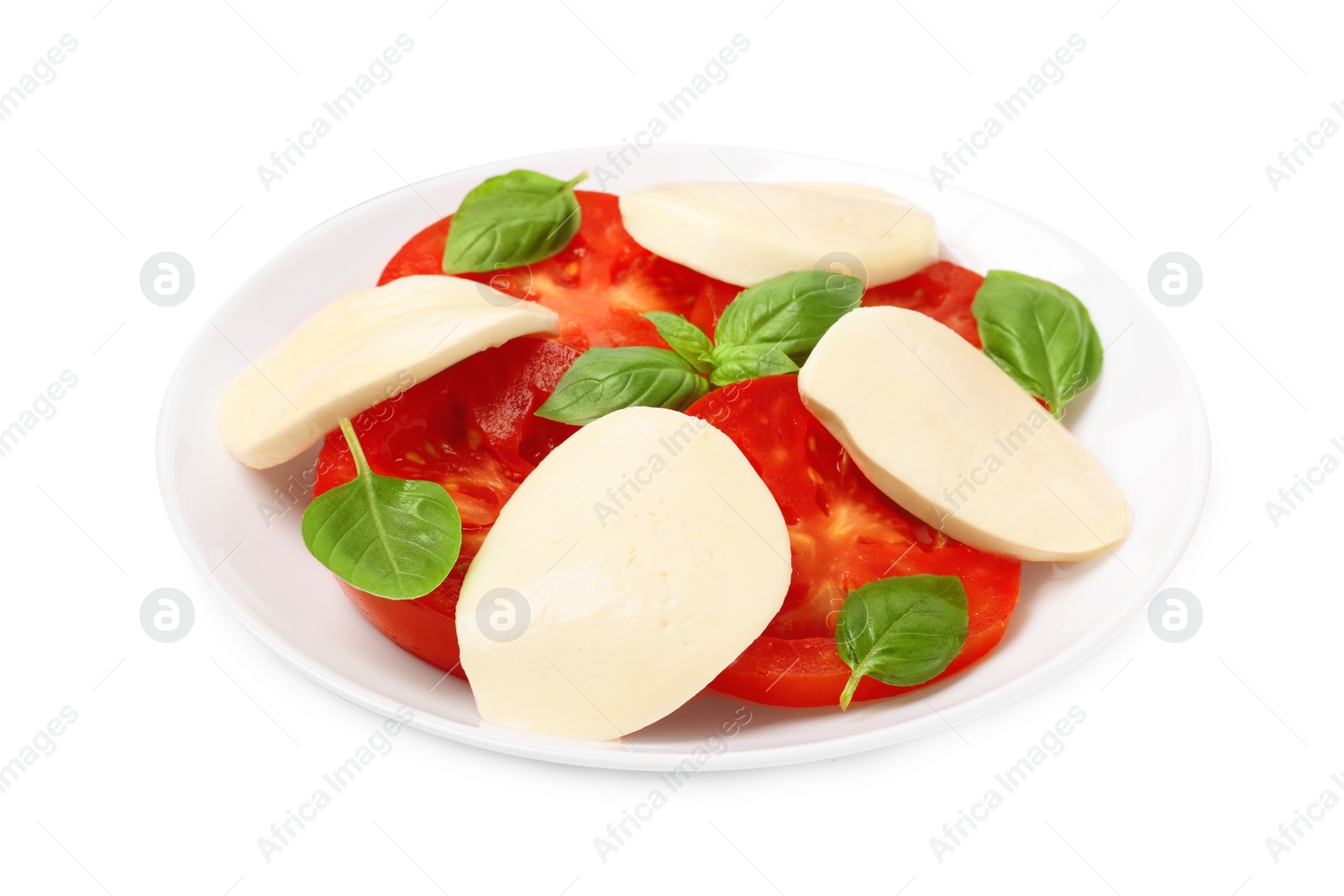 Photo of Plate of delicious Caprese salad with tomatoes, mozzarella and basil isolated on white